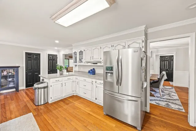 a kitchen with stainless steel appliances a refrigerator sink and cabinets