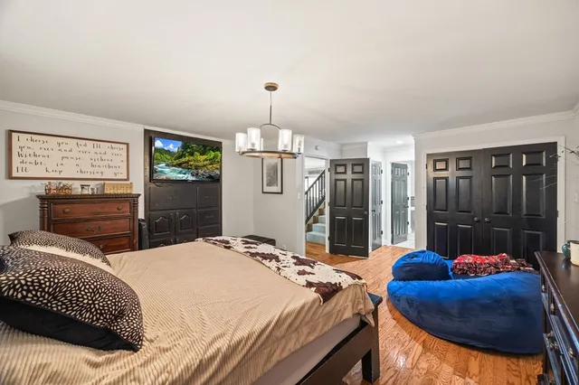 a bed room with a bed mirror and a balcony