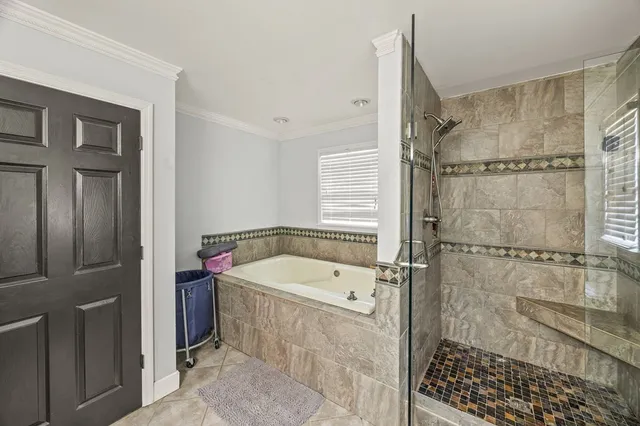 a bathroom with a tub a sink and a shower