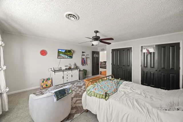 a bedroom with a bed and a couch