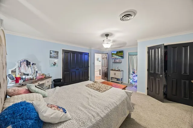 a bedroom with a bed and a walk in closet