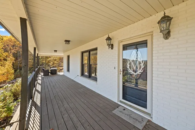 a view of a hallway with wooden floor and windows
