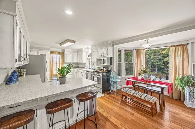 a dining room with furniture and wooden floor