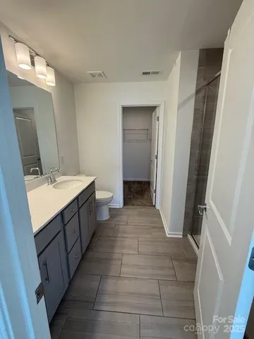 a bathroom with a sink a mirror and a toilet