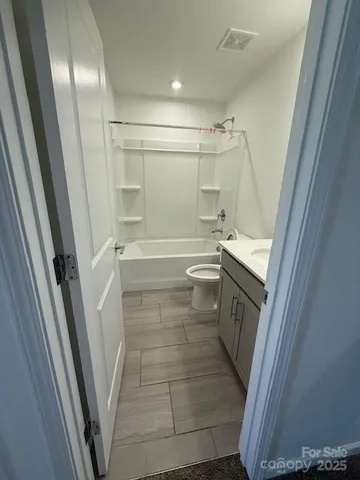 a bathroom with a sink a toilet and a shower