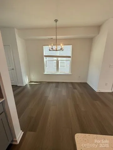 a view of wooden floor and windows in a room