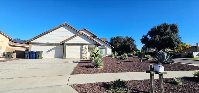 a view of the house with backyard and trees