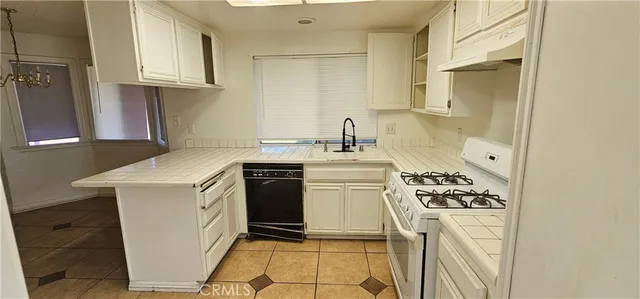 a kitchen with a stove a sink and a refrigerator
