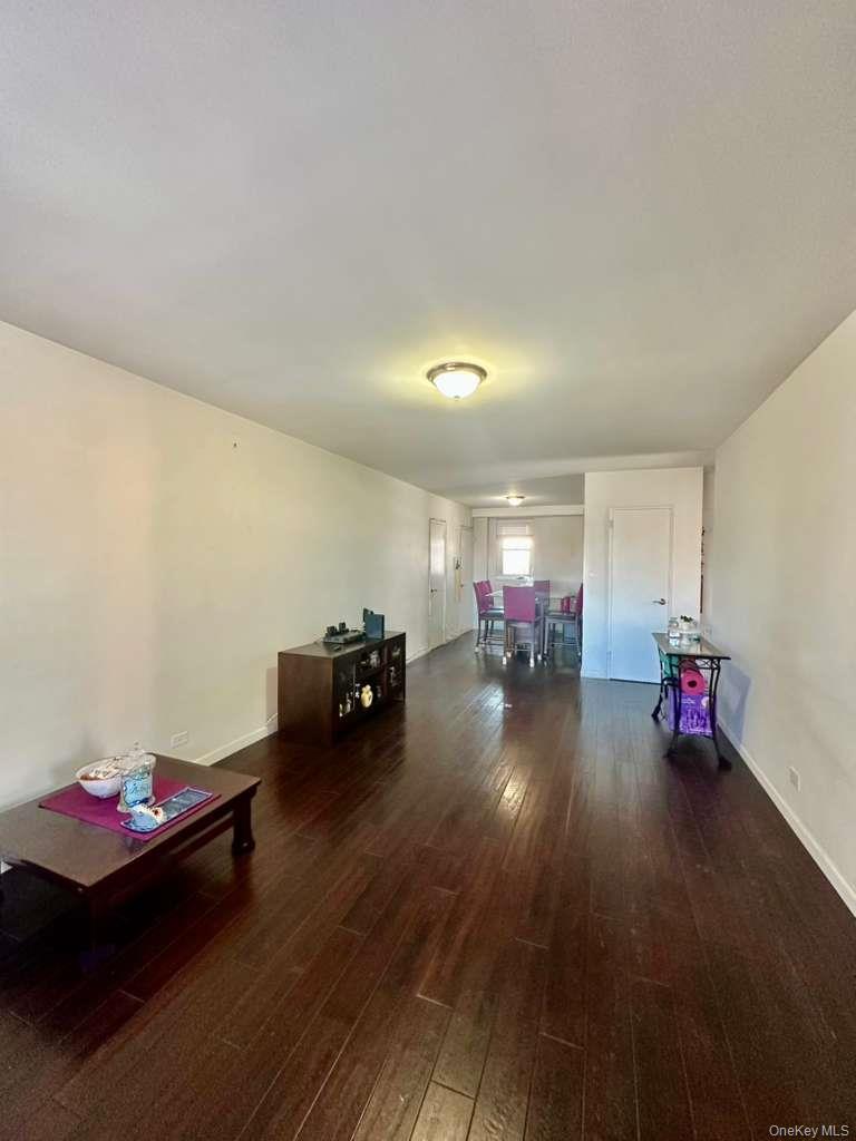 97-07 63rd Road, Unit 6H Queens, NY 11374 - Photo 1 of 17 a living room with furniture and a wooden floor