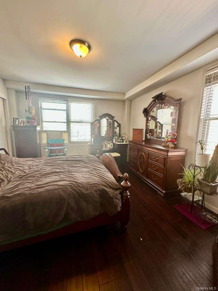 97-07 63rd Road, Unit 6H Queens, NY 11374 - Photo 12 of 17 a bedroom with a bed and wooden floor