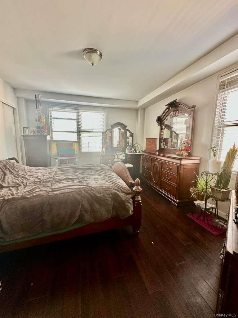97-07 63rd Road, Unit 6H Queens, NY 11374 - Photo 14 of 17 a bedroom with a bed and wooden floor
