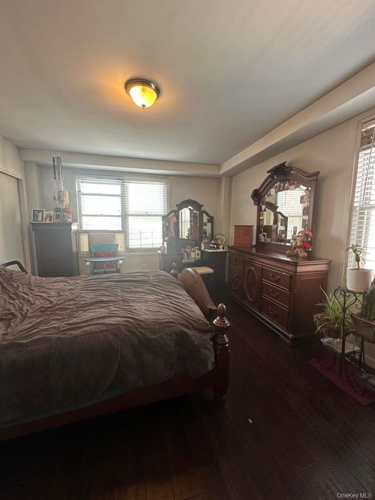 97-07 63rd Road, Unit 6H Queens, NY 11374 - Photo 16 of 17 a bedroom with a bed and a chandelier