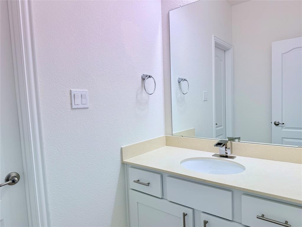 1336 Morning View Road Georgetown, TX 78628 - Photo 34 of 40 A refined bathroom vanity features a single sink set into elegant countertops, complete with a broad mirror.