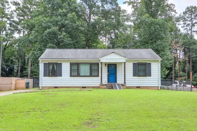 a view of house with a yard