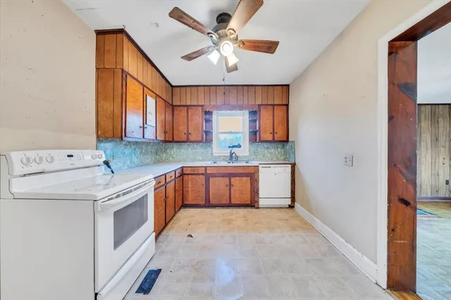 a kitchen with a stove a sink and a refrigerator