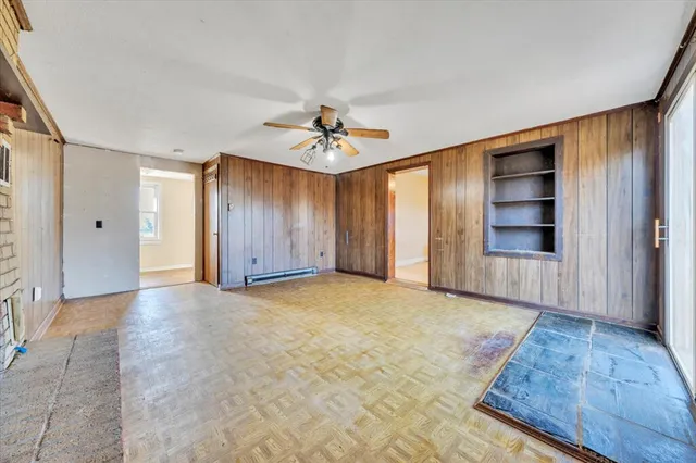 a view of an empty room with a ceiling fan