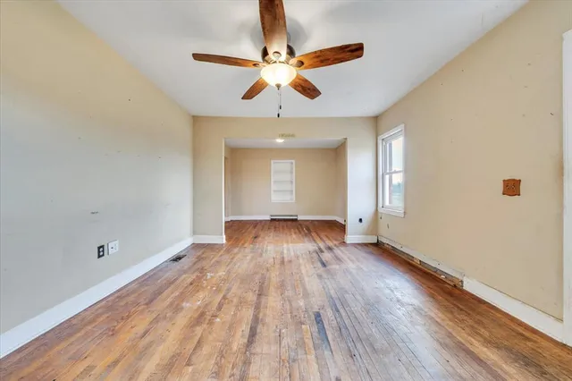 wooden floor in an empty room with a window