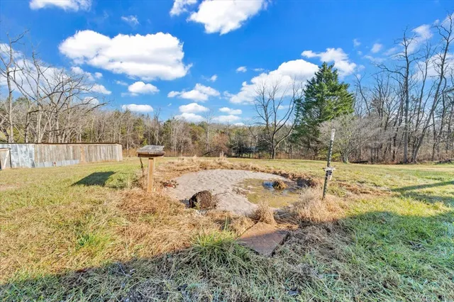 a view of a house with backyard and porch