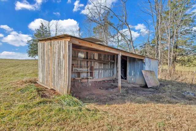 a view of a house with a backyard and a tree