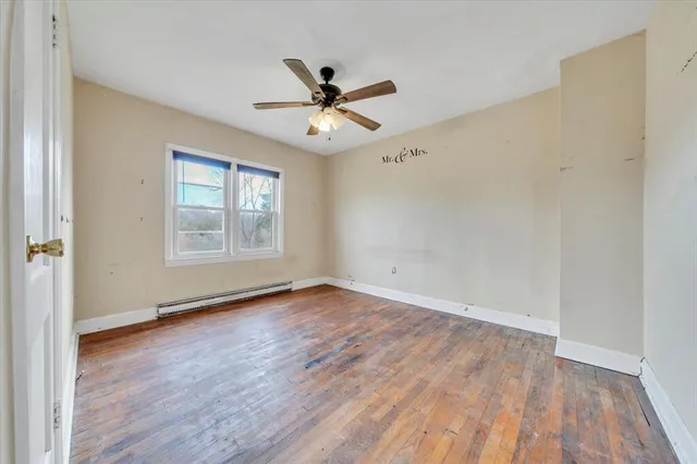 wooden floor in an empty room with a window