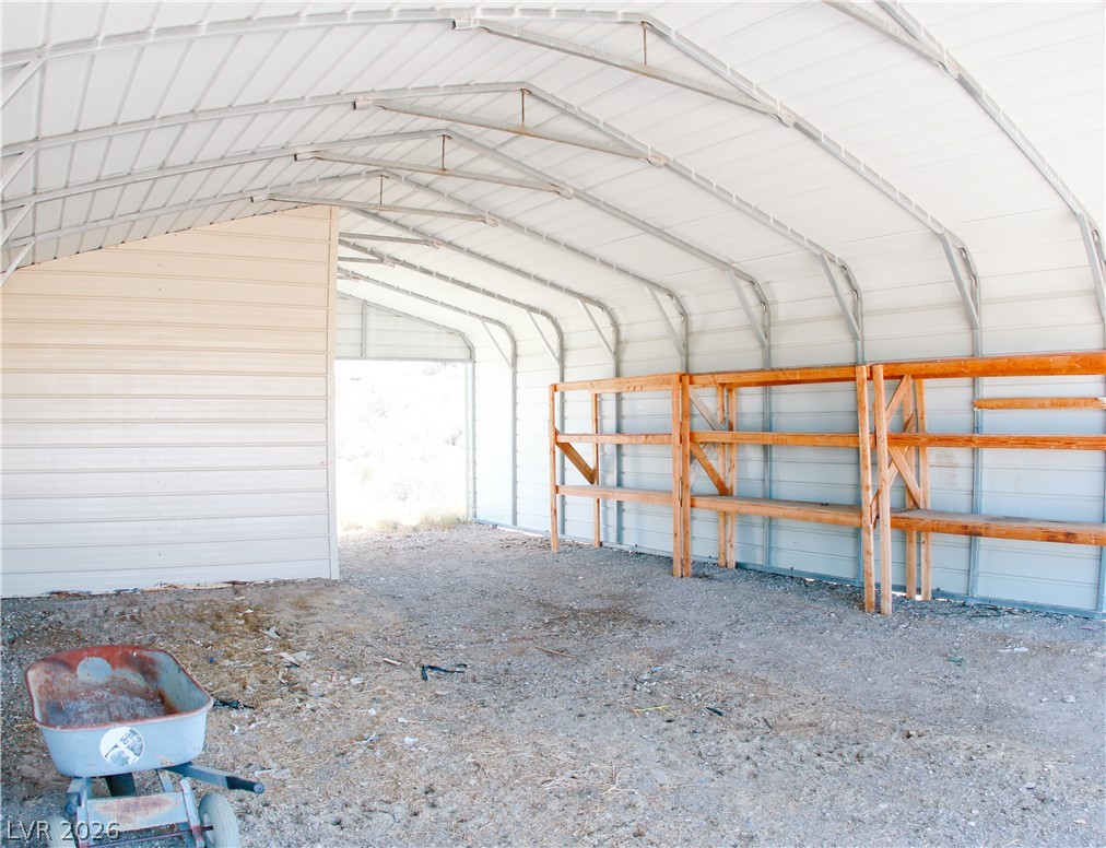 5231 Ruby Way Caliente, NV 89008 - Photo 30 of 35 An airy metal structure with built-in wooden shelving offers versatile storage or workspace.