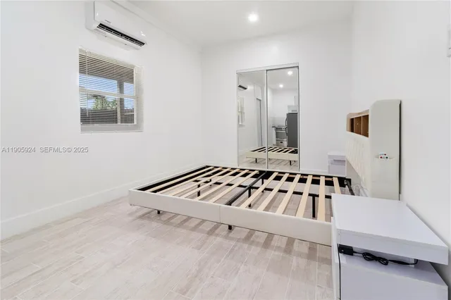 a white house with sink and mirror