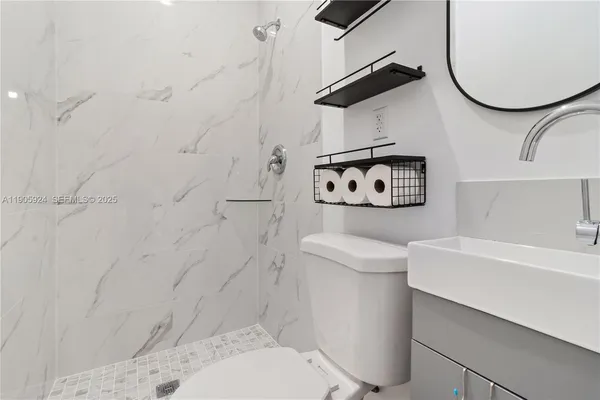 a bathroom with a sink toilet and a shower