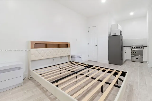 a bedroom with a bed and cabinets