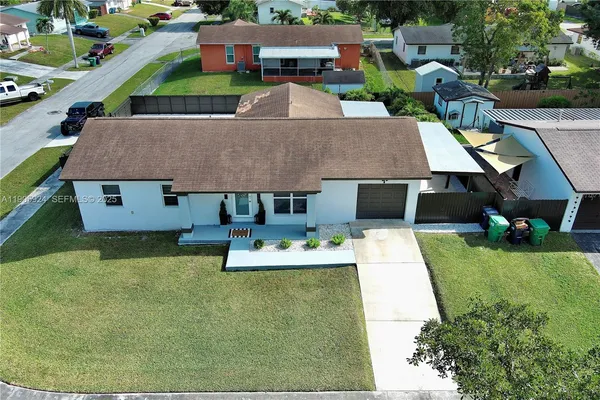 a aerial view of a house with a yard porch and sitting area