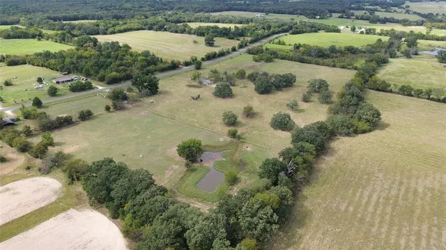 an aerial view of a houses with yard