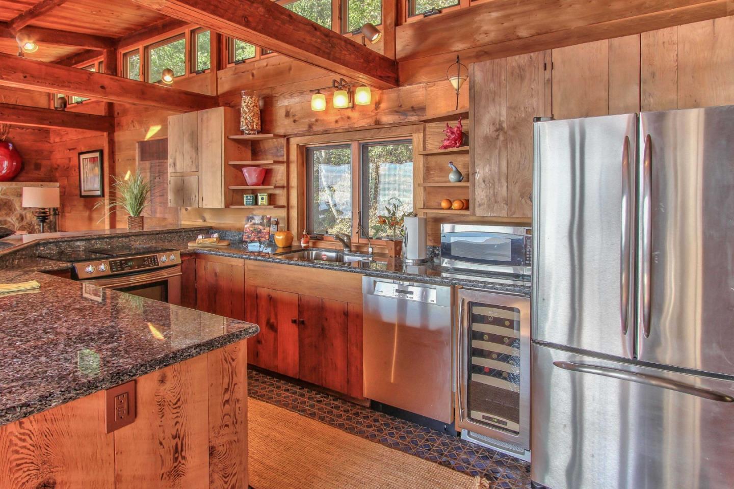 51410 Partington Ridge Road Big Sur, CA 93920 - Photo 11 of 45 a kitchen with stainless steel appliances granite countertop a refrigerator a sink and a stove