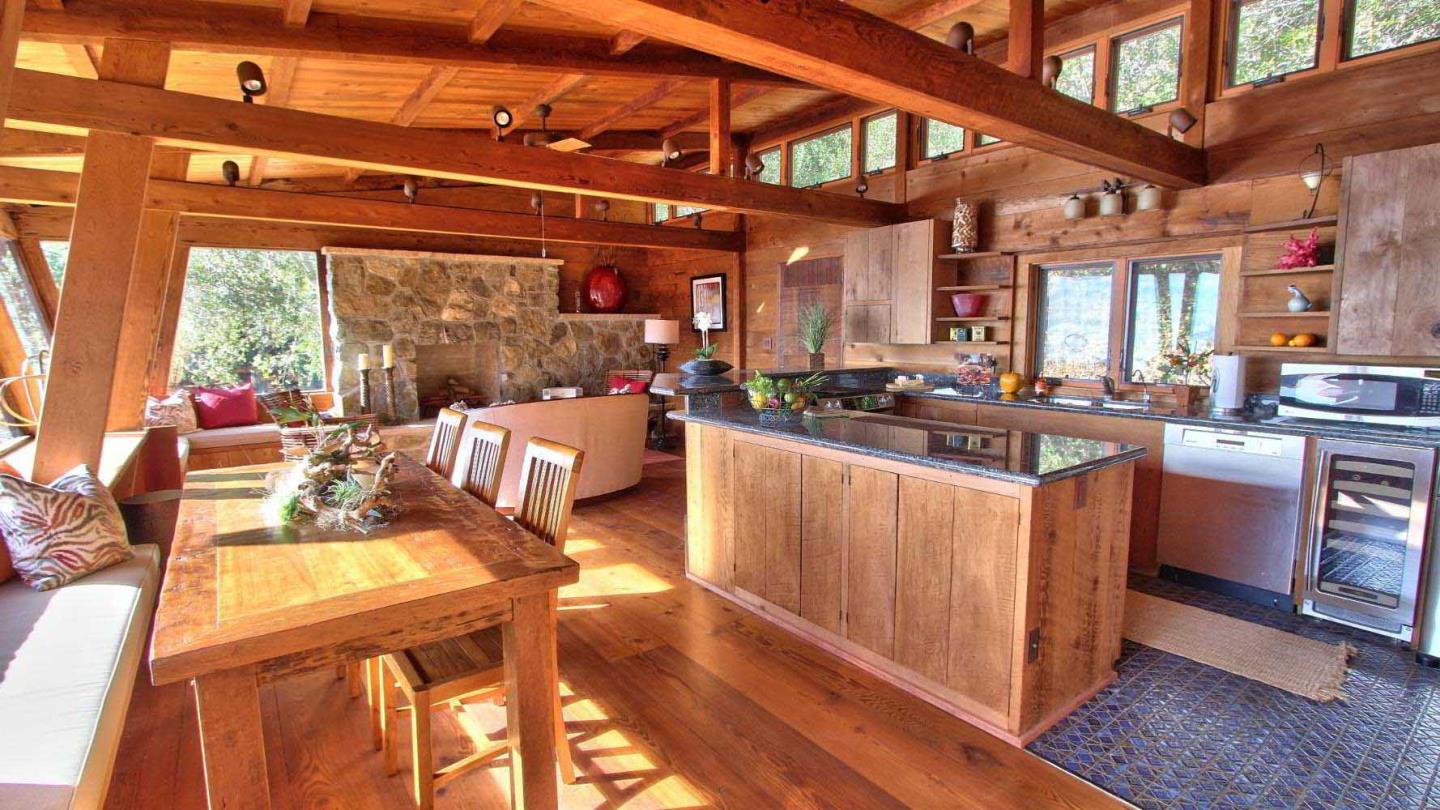 51410 Partington Ridge Road Big Sur, CA 93920 - Photo 13 of 45 a kitchen with stainless steel appliances kitchen island granite countertop a large stove a large window with wooden floor and cabinets