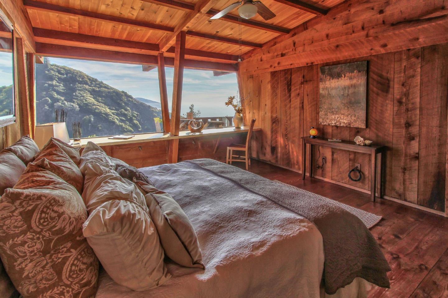 51410 Partington Ridge Road Big Sur, CA 93920 - Photo 15 of 45 a bed sitting in a bedroom next to a window