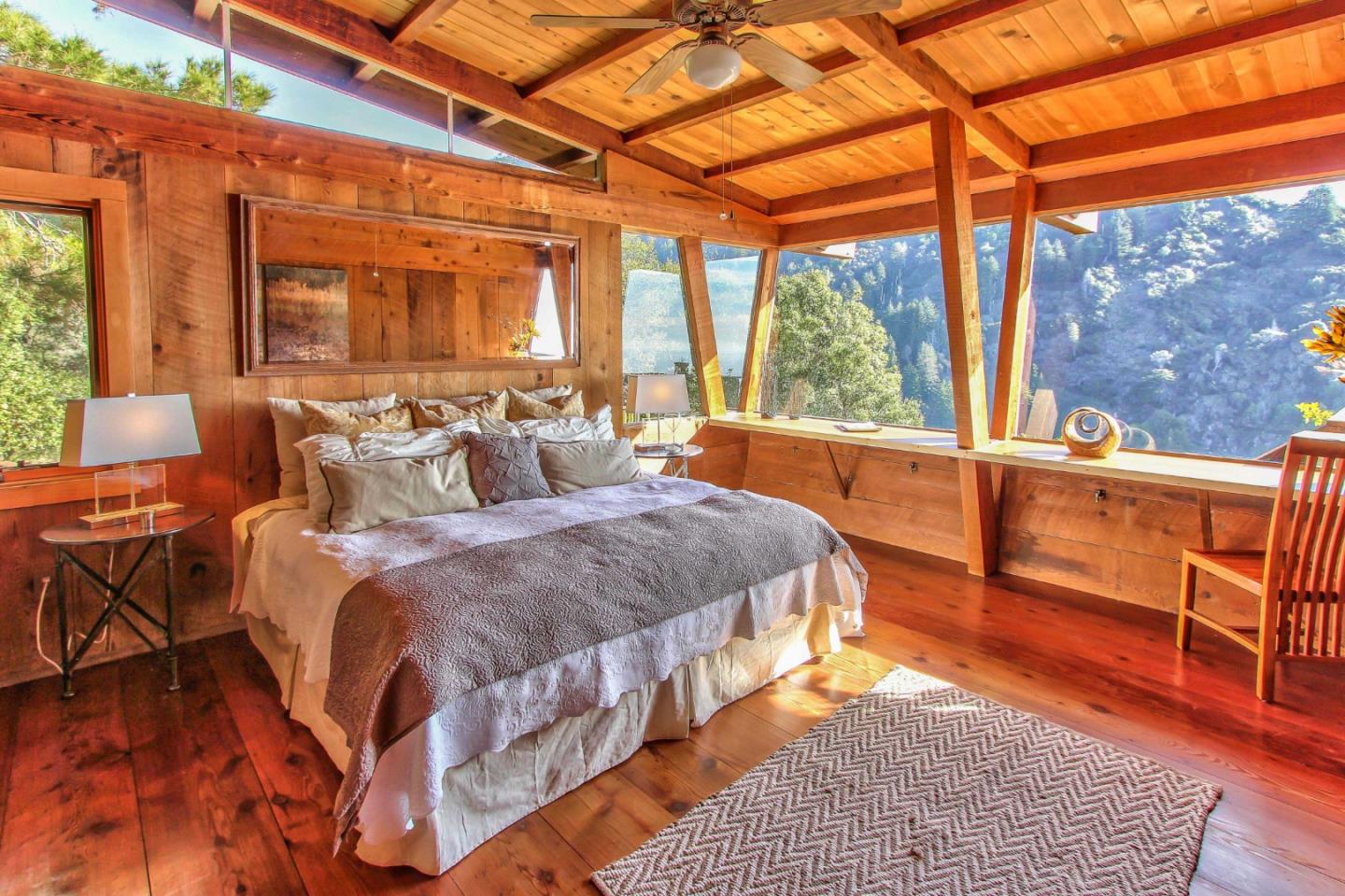 51410 Partington Ridge Road Big Sur, CA 93920 - Photo 16 of 45 a spacious bedroom with a bed and wooden floor