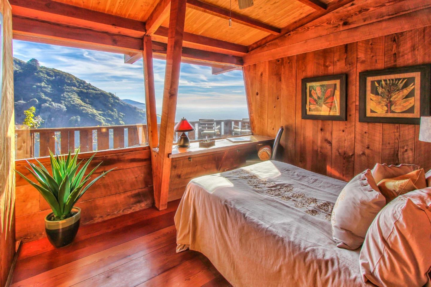 51410 Partington Ridge Road Big Sur, CA 93920 - Photo 19 of 45 a bedroom with a bed and wooden floor