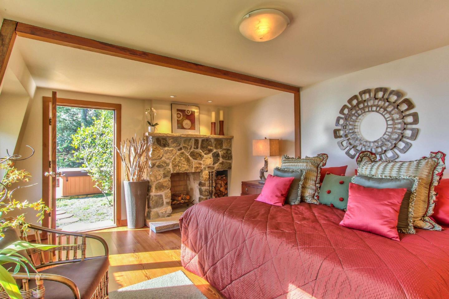 51410 Partington Ridge Road Big Sur, CA 93920 - Photo 22 of 45 a bedroom with a large bed and a large window