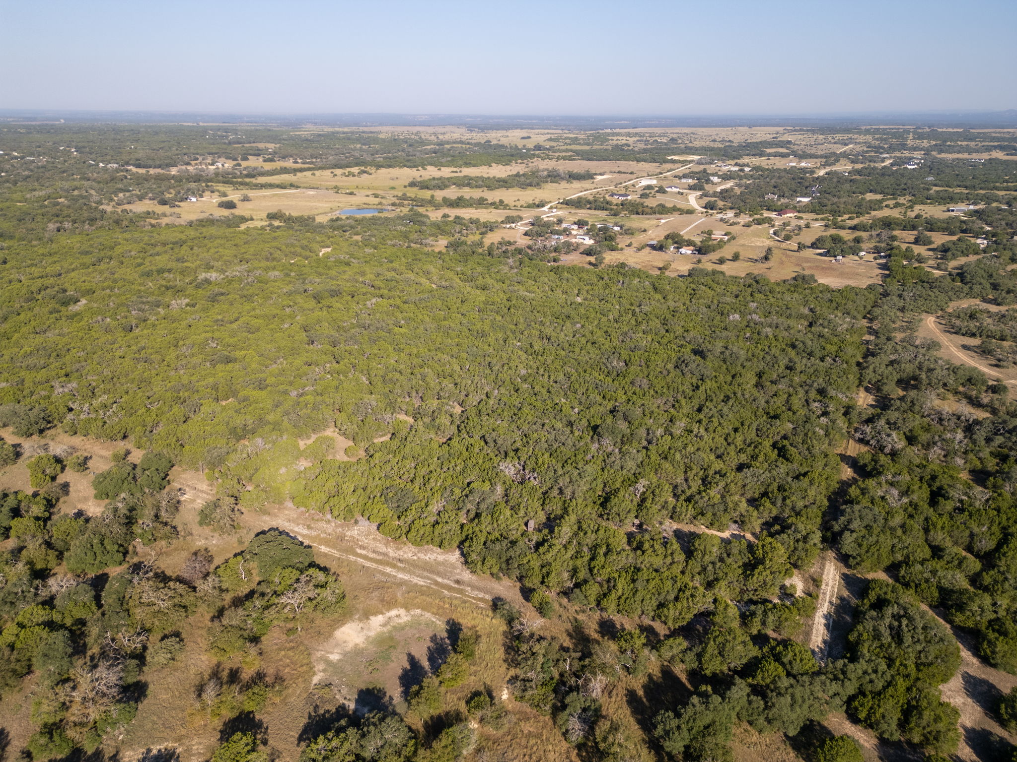112 Loop 308 Briggs, TX 78608 - Photo 23 of 37 View of property location featuring a heavily wooded area