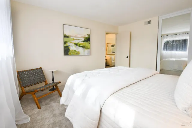 a bedroom with a bed and a chair