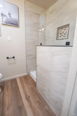 a view of a hallway with wooden floor