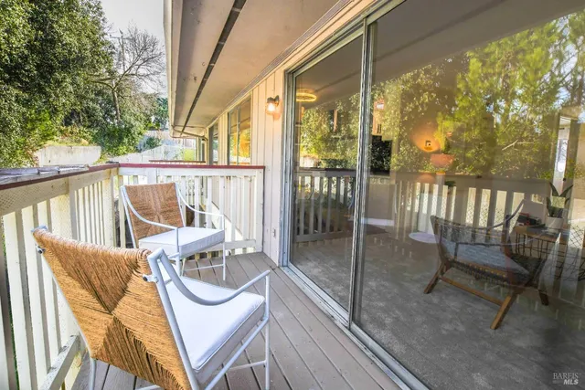 a view of a chair and tables in the balcony