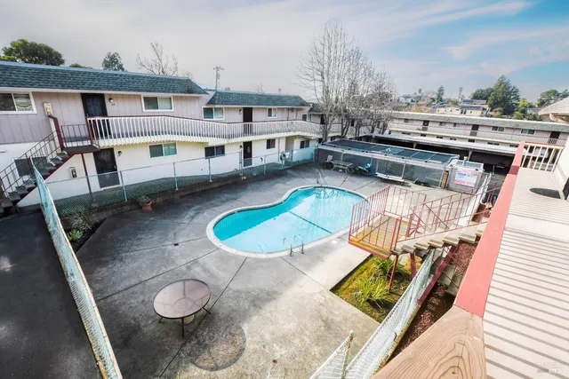 an aerial view of a house with a swimming pool