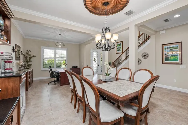 a kitchen with granite countertop stainless steel appliances a sink window and cabinets