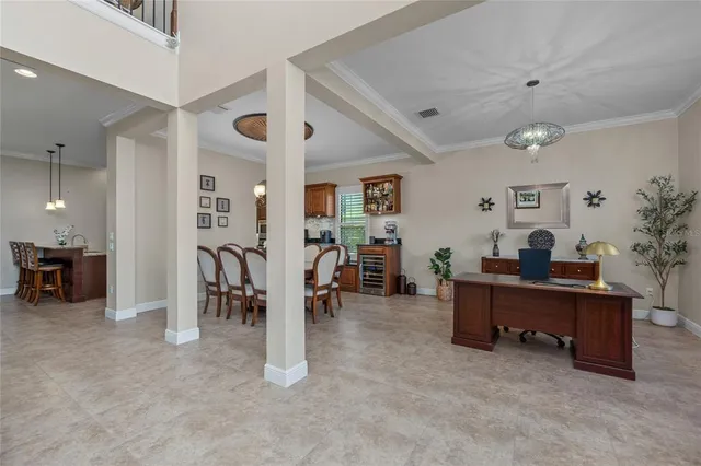 a kitchen with a refrigerator a sink and a wooden floor