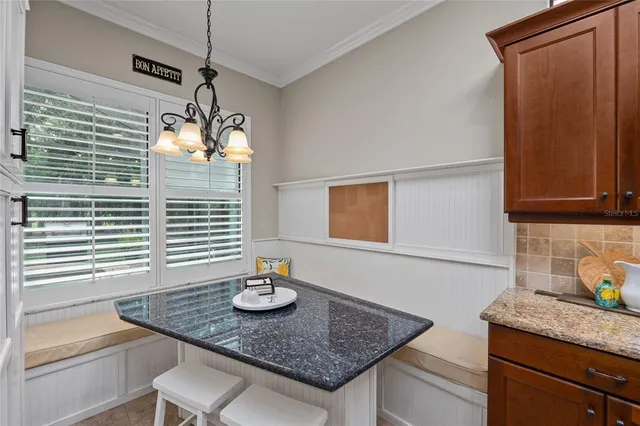 a bathroom with a granite countertop sink a mirror and a shower