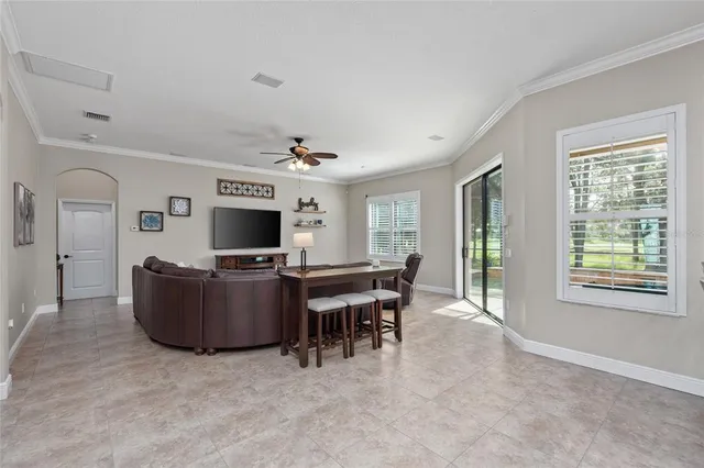a spacious bedroom with a bed and a chandelier