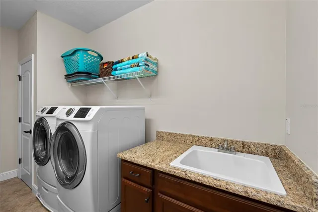 an aerial view of a house with yard swimming pool and outdoor seating