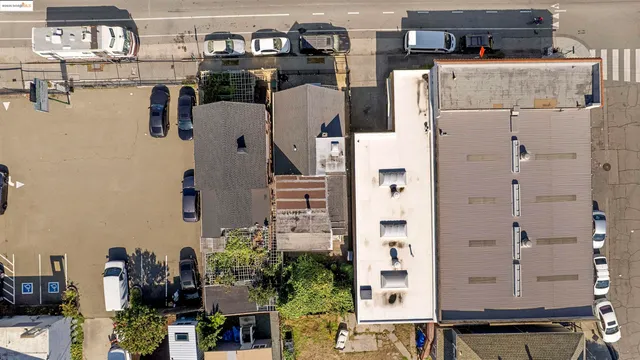 an aerial view of residential houses with outdoor space and parking