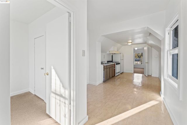a view of a kitchen with a sink and refrigerator