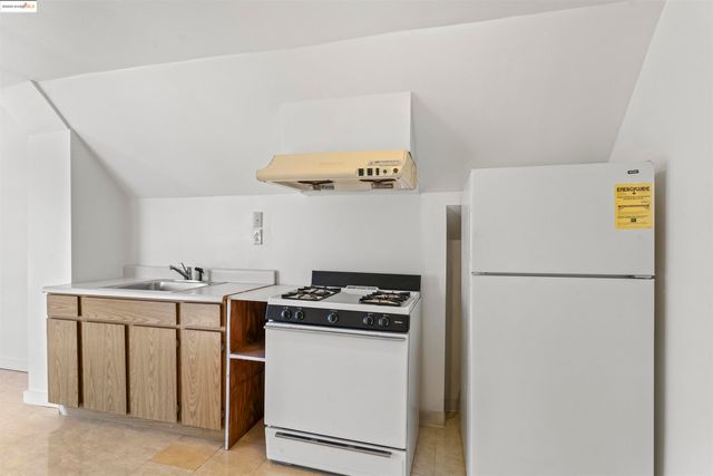 a kitchen with a refrigerator and a stove
