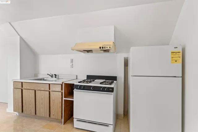 a kitchen with a refrigerator and a stove